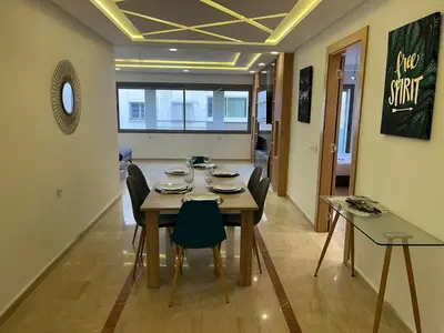 a dining room with a table and chairs at downtown luxurious flat quartier Gauthier in Casablanca