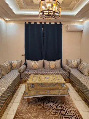 a living room with two couches and a table at Alia Apartment 25 in Casablanca