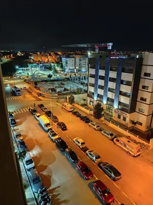 a group of cars parked in a parking lot at night at Alia Apartment 25 in Casablanca