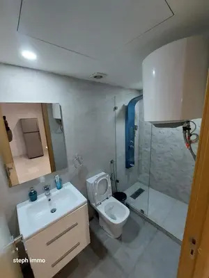 a bathroom with a toilet and a sink and a shower at Res in Casablanca