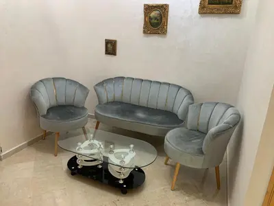 three chairs and a table in a room at Al Kawtar in Mansouria