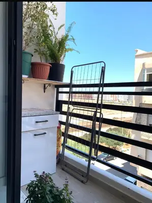 a metal cart on a balcony with plants at Hay al qods in Casablanca