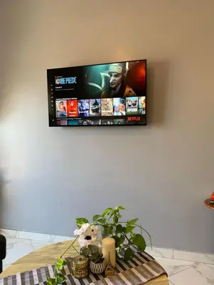 a flat screen tv hanging on a wall at Hay al qods in Casablanca