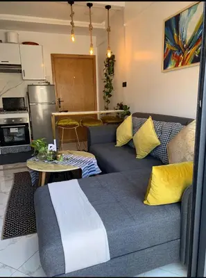 a living room with a couch and a kitchen at Hay al qods in Casablanca