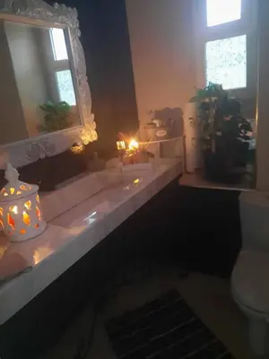a bathroom with a window and a counter with candles at Villa with rooftop bar overlooking sea, pool & vegetable garden in Tamaris