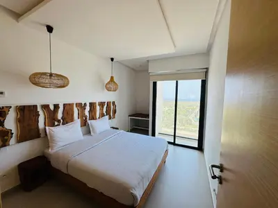 a bedroom with a bed and a large window at Unique apartment in Prestigia Hay Riad Rabat in Rabat