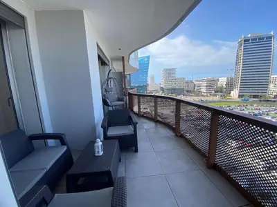 a balcony of a building with a view of a city at Central Luxury Apartment with Fast Fiber WiFi, Panoramic Balcony & Free Parking in Casablanca CFC Casa Finnance City in Casablanca