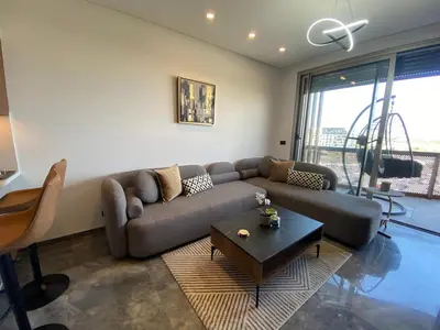 a living room with a couch and a coffee table at Central Luxury Apartment with Fast Fiber WiFi, Panoramic Balcony & Free Parking in Casablanca CFC Casa Finnance City in Casablanca