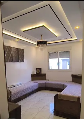 a living room with a couch and a chandelier at apartment a casablanca in Dar Ben Abdallah Ben Dehbi