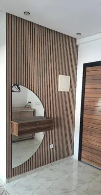 a room with a wooden wall with a mirror at apartment a casablanca in Dar Ben Abdallah Ben Dehbi