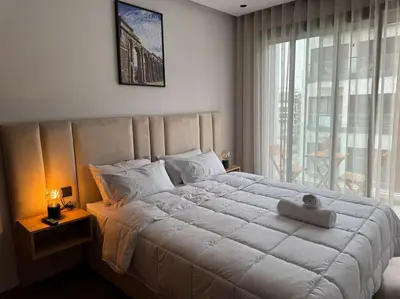 a bedroom with a large white bed and a window at Studio Chic Princesses Maarif - Wifi haut débit in Casablanca
