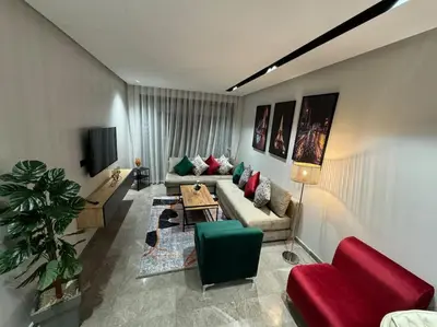 a living room with a couch and a table at Studio Chic Princesses Maarif - Wifi haut débit in Casablanca