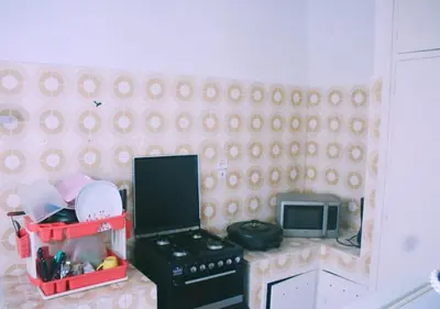a toy kitchen with a stove and a microwave at Comfortable Room 2 at Homestay Casablanca in Maarif