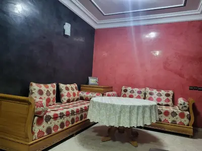 a living room with a couch and a table at Appartement à Casablanca in Casablanca