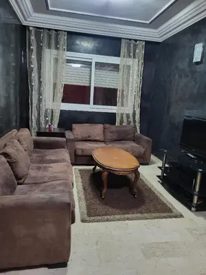 a living room with a couch and a coffee table at Appartement à Casablanca in Casablanca