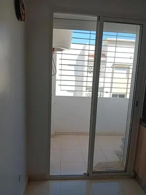 a sliding glass door with a view of a room at Appartement Jad & Rim in Bouznika