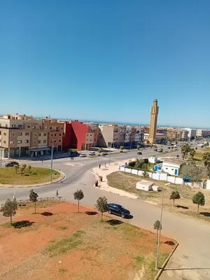 a city street with a car driving down a road at Appartement Jad & Rim in Bouznika