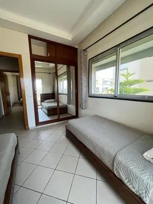 a bedroom with a bed and a large window at Mansoria in Mansouria