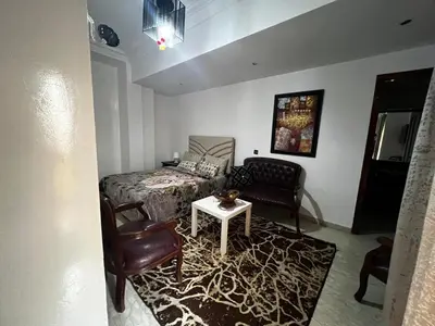 a bedroom with a bed and a couch and a table at Pure Space - by Nero in Casablanca