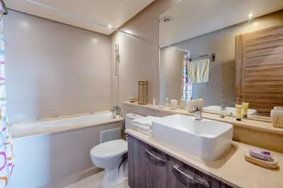 a bathroom with a sink and a toilet and a tub at Comfort Stay by Mohammed V Airport in Nouaseur
