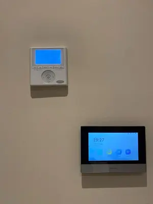 a clock on a wall with a monitor on a wall at Appart youssef in Casablanca