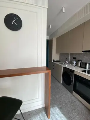 a kitchen with a clock on the wall at Studio moderne rooftop et gym Triangle d or casablanca in Casablanca