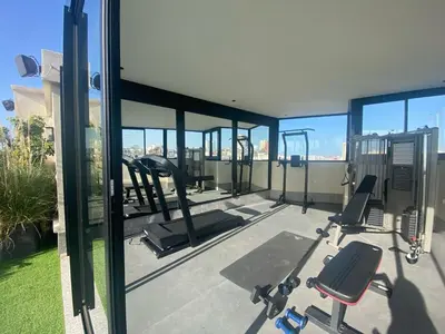 a gym with cardio equipment on the roof of a house at Studio moderne rooftop et gym Triangle d or casablanca in Casablanca