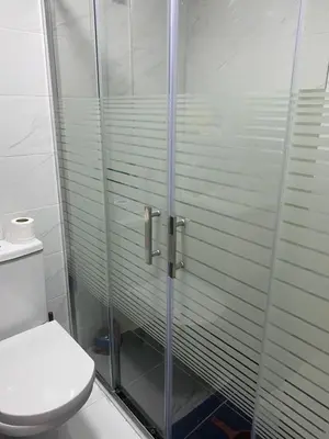 a bathroom with a glass shower with a toilet at Jnane in Sidi Rahal