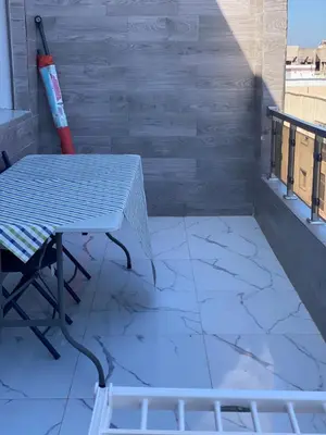 a table on a balcony with a tile floor at Jnane in Sidi Rahal