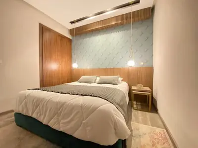 a bedroom with a large bed and a side table at Welcome to Casablanca in Casablanca