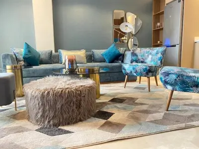 a living room with a blue couch and chairs at Welcome to Casablanca in Casablanca