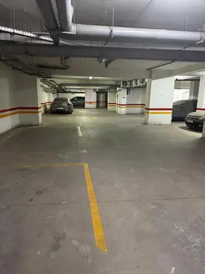 a parking garage with two cars parked in it at Appartement de lux avec piscine in Mohammedia