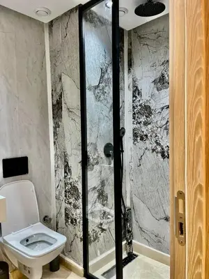 a bathroom with a toilet and a walk in shower at Bat infinity living in Casablanca