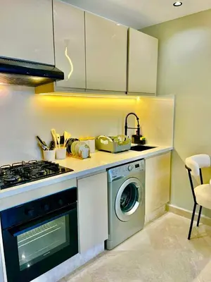 a kitchen with a stove and a washing machine at Bat infinity living in Casablanca