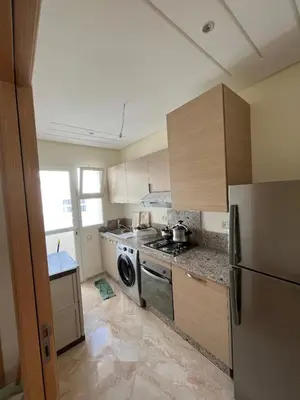 a kitchen with a stove and a dishwasher at Ramoflores , sidi rahal in Sidi Rahal