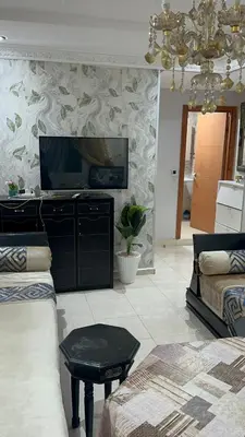 a living room with a couch and a flat screen tv at appart 206 in Temara