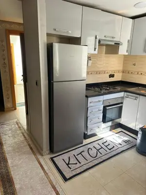 a kitchen with a stainless steel refrigerator and a stove at appart 206 in Temara