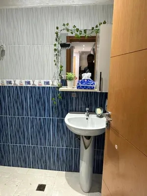 a bathroom with a sink and a mirror at appart 206 in Temara