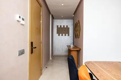 a hallway with a table and chairs in a room at Luxurious and comfortable in Prestigia in Rabat