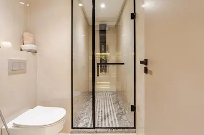 a bathroom with a toilet and a glass shower at Corniche Guest idéal pour un séjour Inoubliable in Casablanca