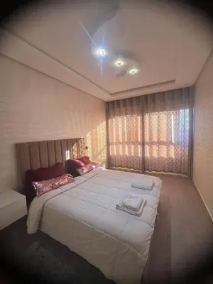 a bedroom with a large white bed with a window at Dar al bahr in Rabat