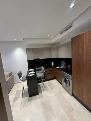 a kitchen with a washer and dryer in a room at Résidence Signature Leving in Maarif