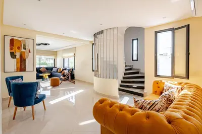 a large living room with a couch and chairs at Charming Villa in Harhoura in Temara