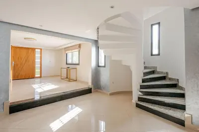 a hallway with a staircase in a house at Charming Villa in Harhoura in Temara