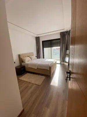 a bedroom with a bed and a large window at Appartement in Casablanca