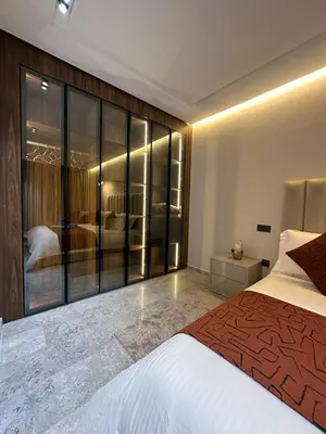 a bedroom with a bed and a large glass wall at Deux studios luxueux à palmiers Casablanca in Casablanca