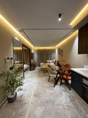 a living room with a couch and a table at Deux studios luxueux à palmiers Casablanca in Casablanca