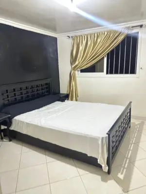 a large bed in a room with a window at Maison in Mohammedia