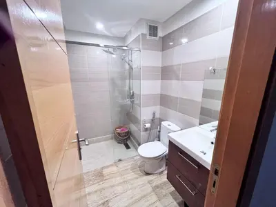 a bathroom with a shower and a toilet and a sink at Beachfront apartment in Rabat