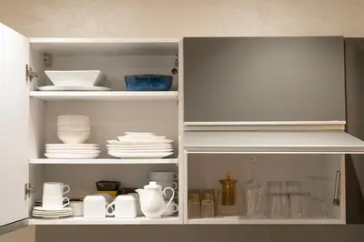 a cupboard with plates and dishes in it at Prime location unmatched comfort in Casablanca